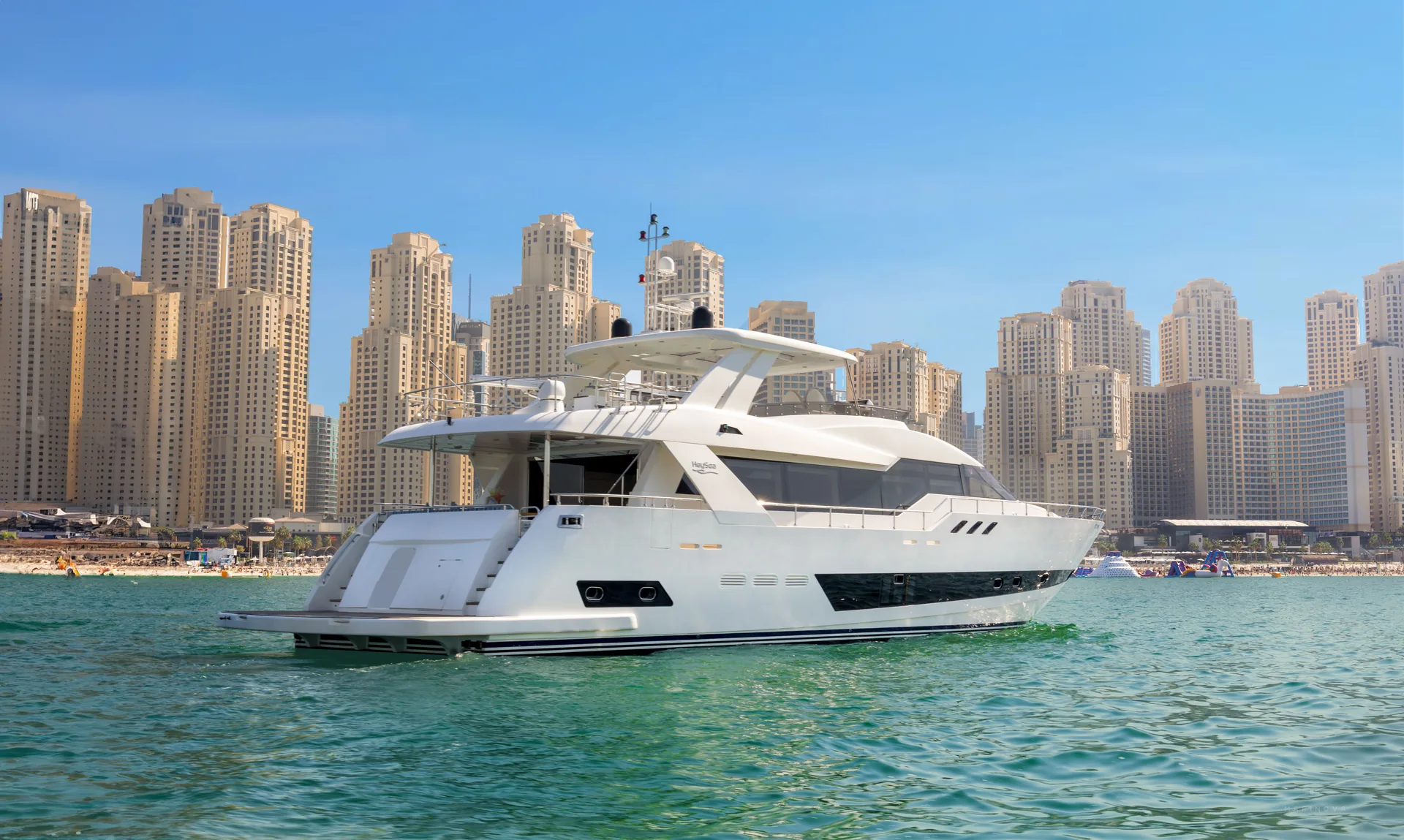 Fuego 96 aft three-quarter view with JBR skyline