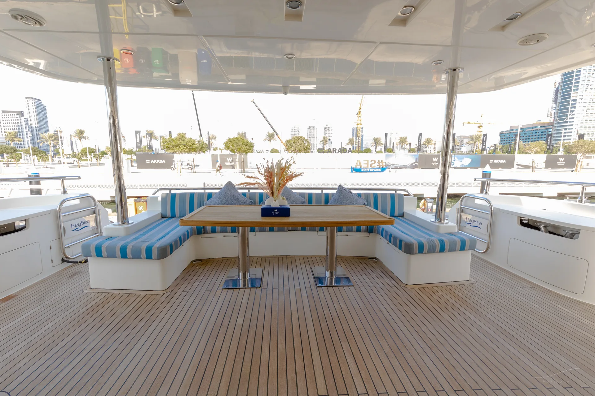 Fuego 96 aft deck with U-lounge and dining table