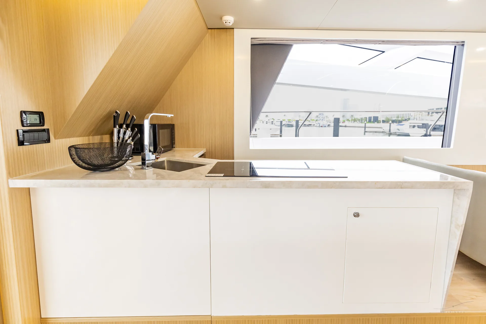 Isla 60 galley with marble counter and induction stove