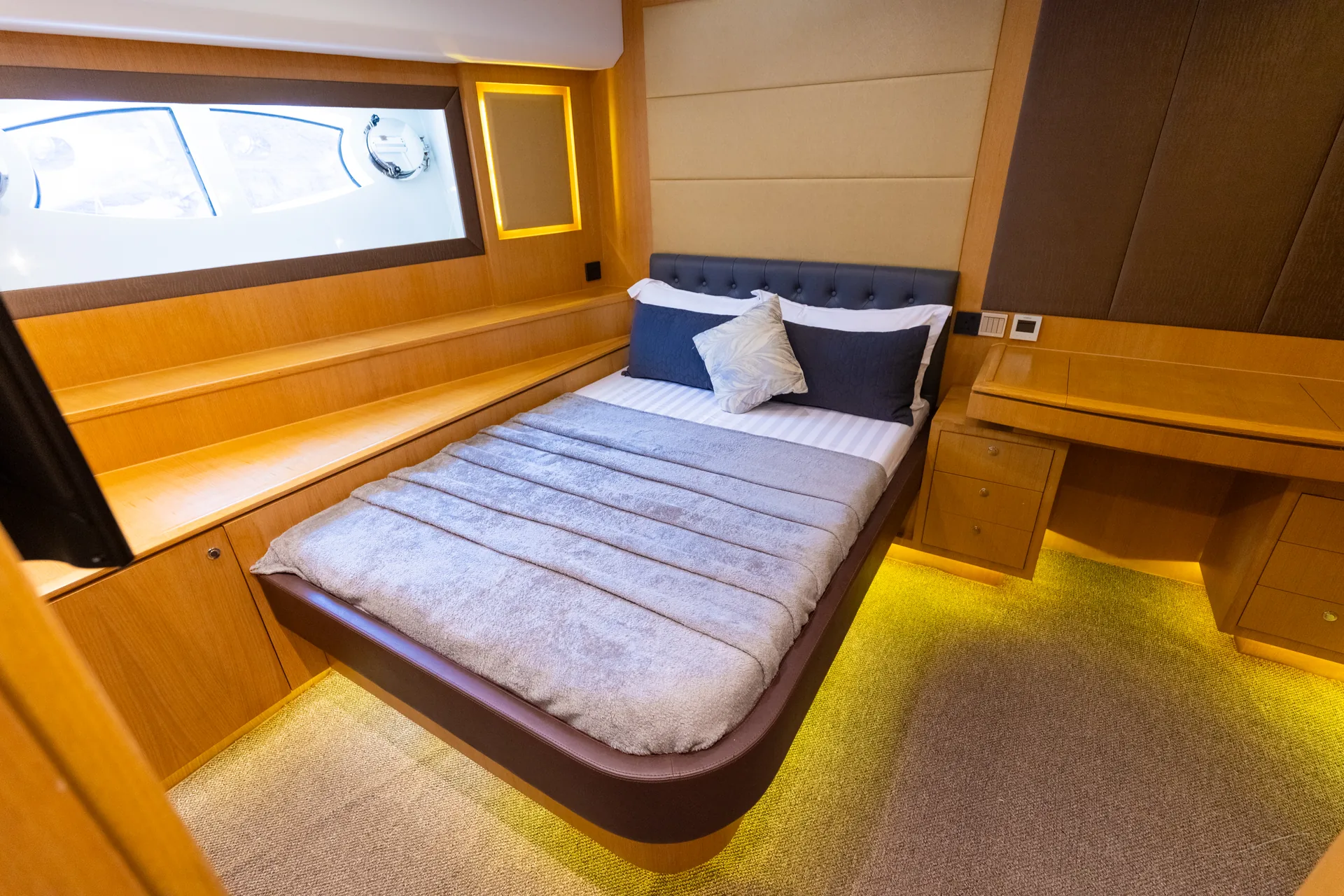 Rosso 110 cabin with warm wood panelling and side window