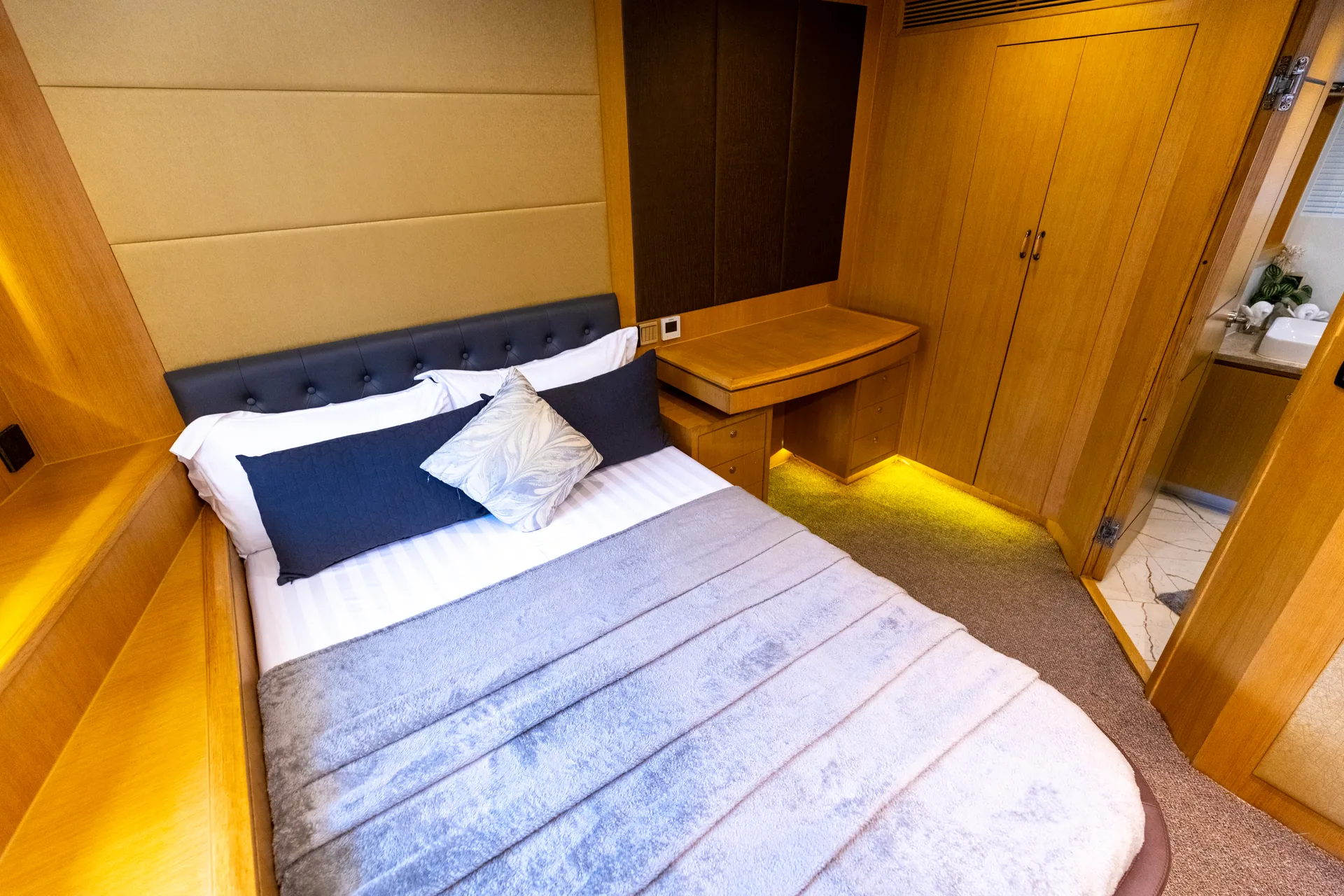 Rosso 110 guest cabin with navy quilted headboard