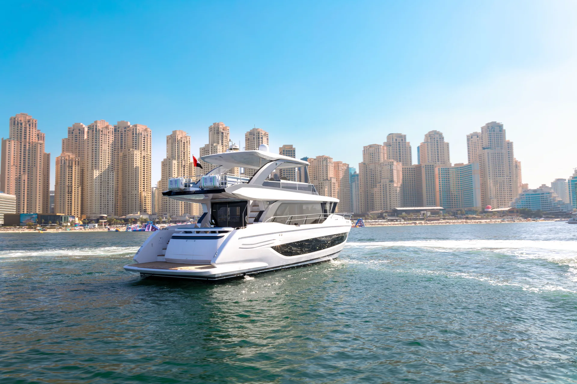 Vela 63 aft three-quarter view with JBR skyline