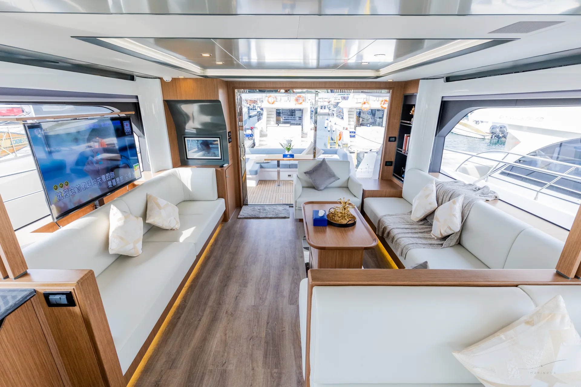 Vela 63 main saloon with TV and open aft doors