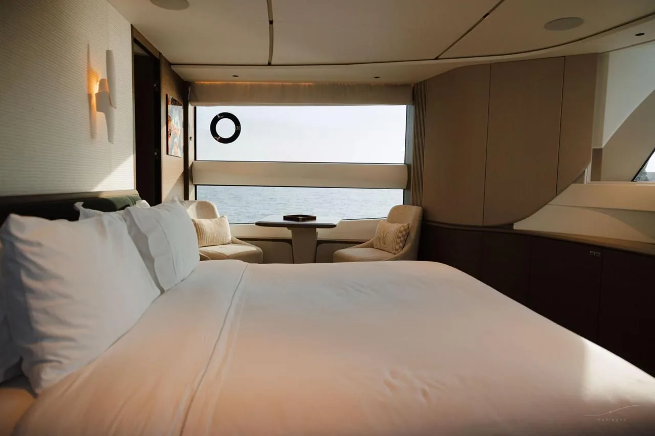 Princess X95 master cabin with lounge chairs and wide window