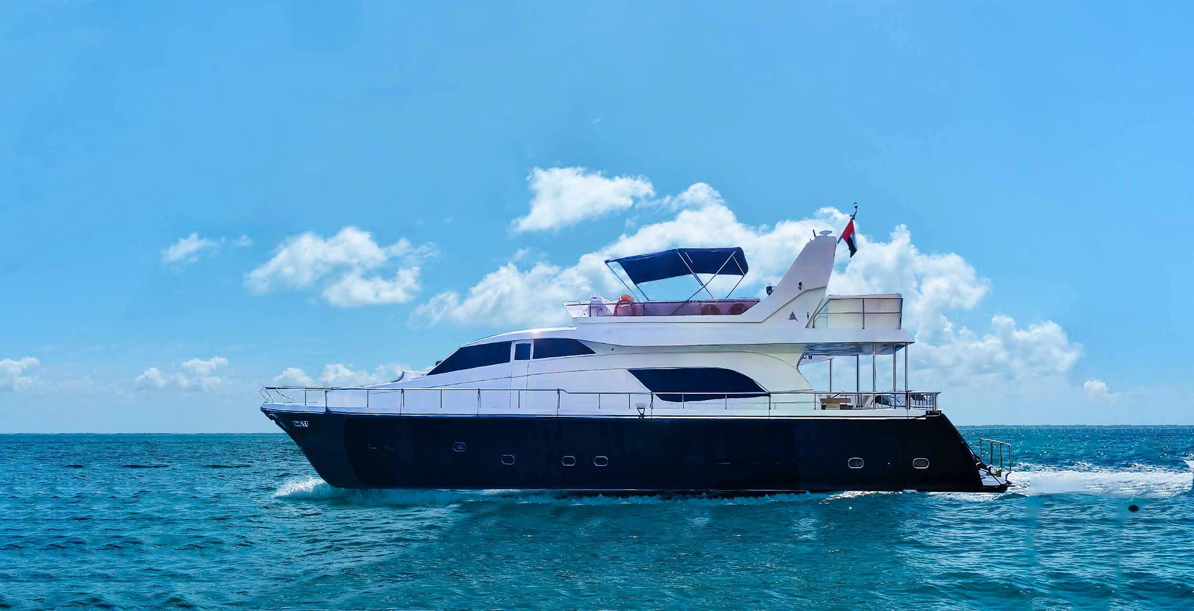 80 feet yacht rental Dubai full side profile cruising on open water.