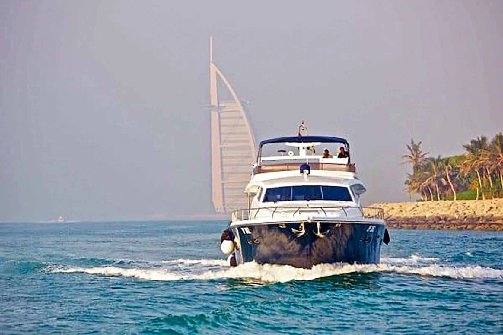 80 feet yacht rental Dubai bow view while cruising near Burj Al Arab.