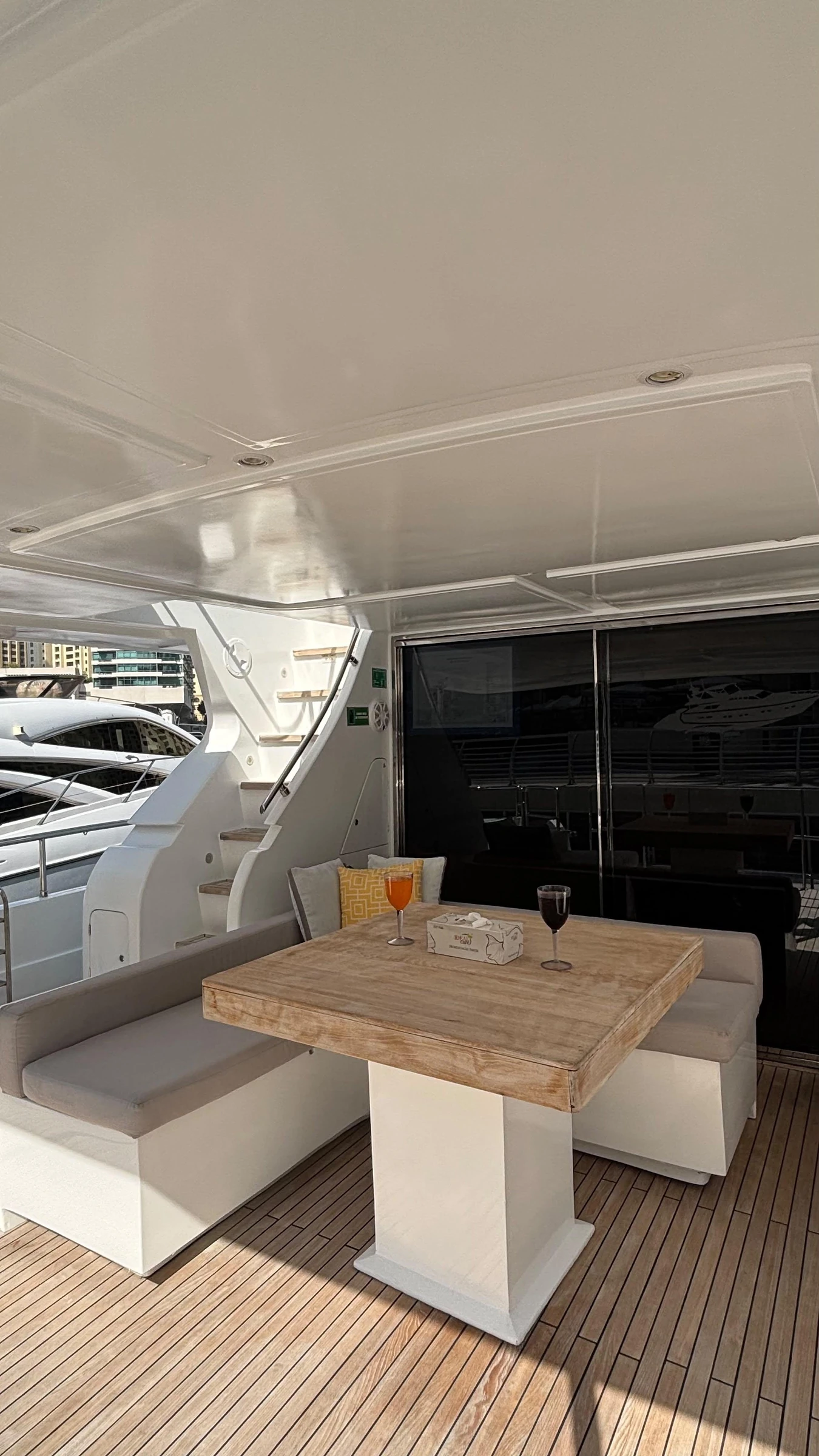 80 feet yacht rental Dubai covered aft dining area with table and seating.