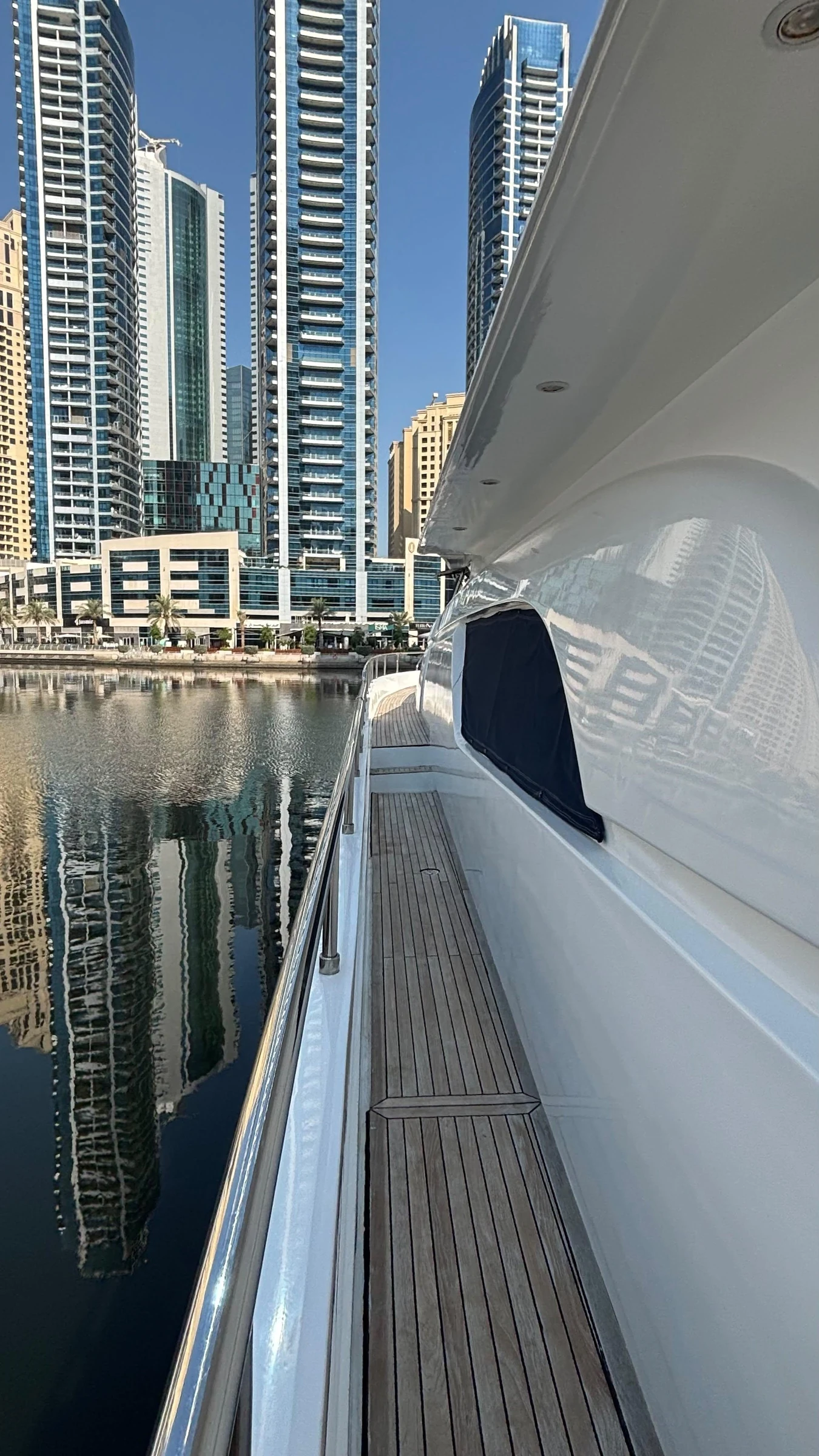 80 feet yacht rental Dubai side deck beside the marina skyline.