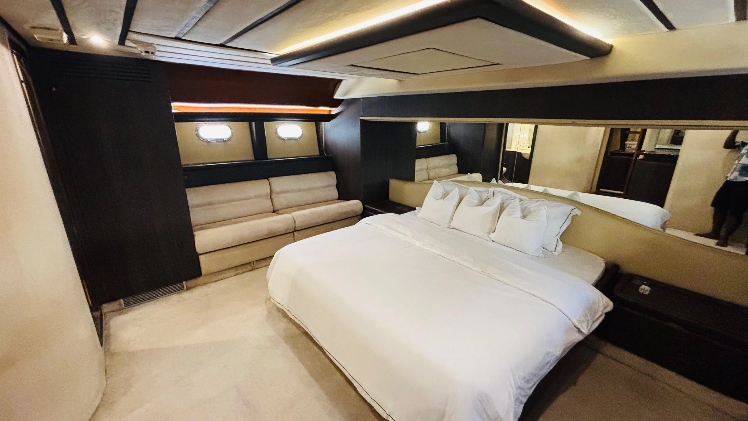 80 feet yacht rental Dubai master cabin with double bed and lounge seating.