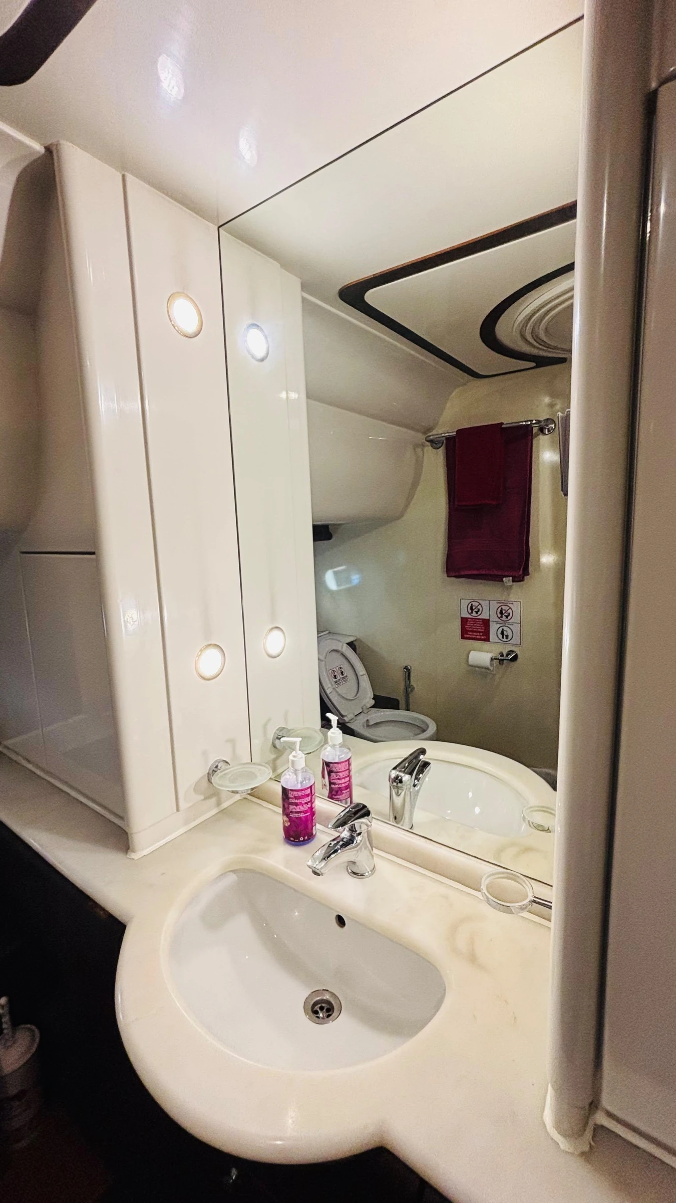 80 feet yacht rental Dubai bathroom vanity and illuminated mirror.