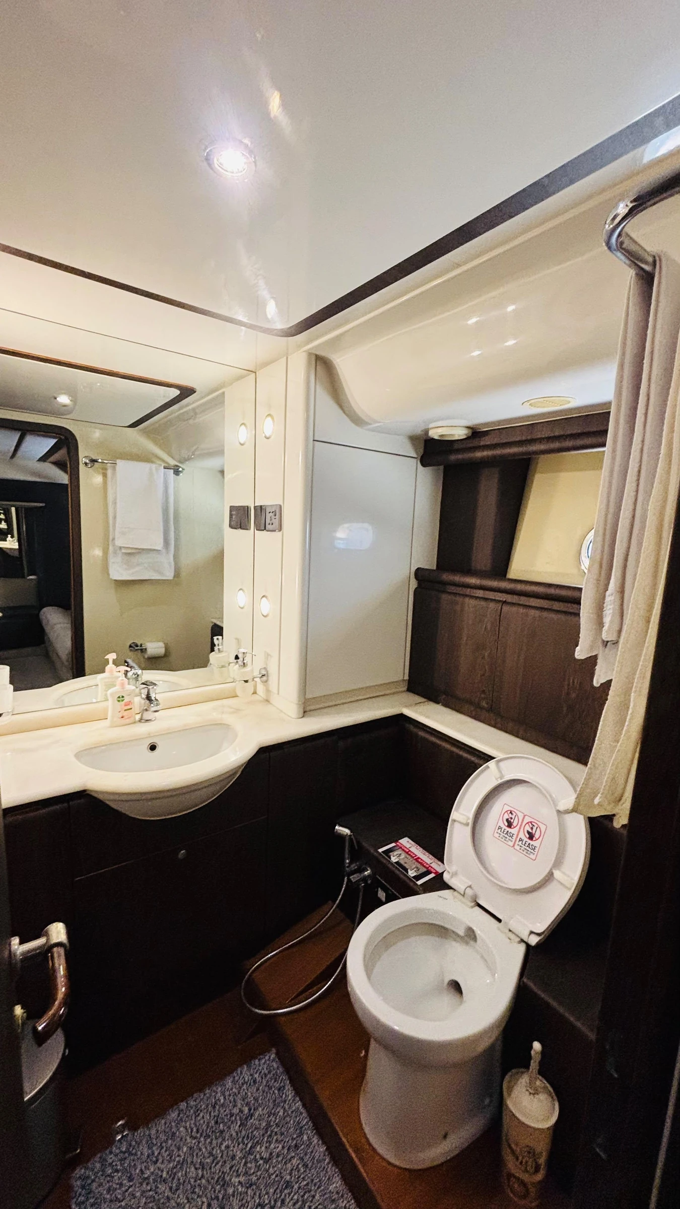 80 feet yacht rental Dubai bathroom with toilet, vanity and shower area.
