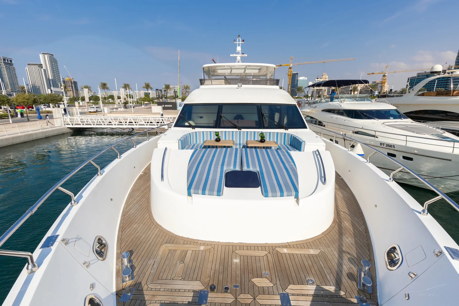 Fuego 96 bow sunpad with marina view