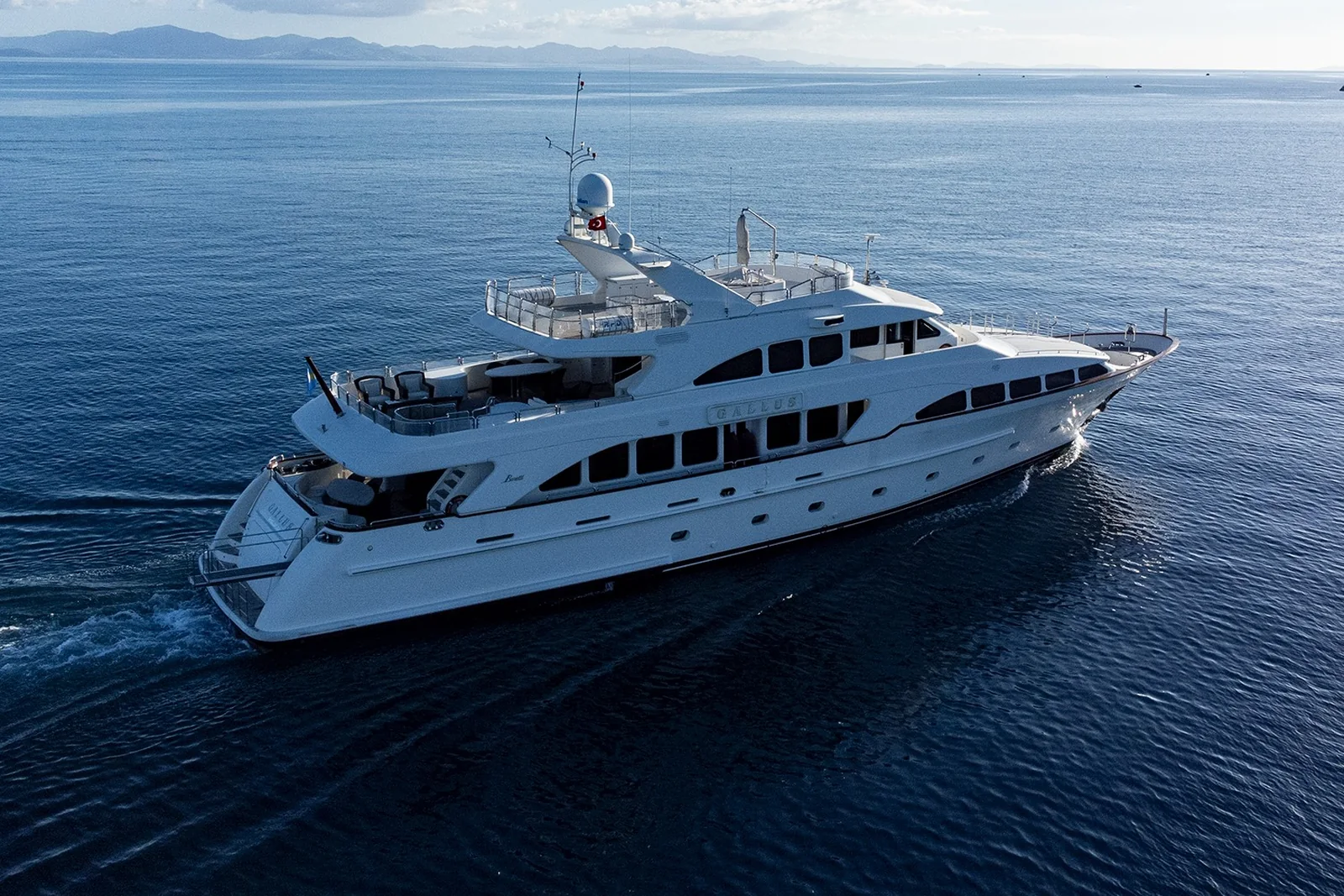 Marinova Gallus 115 under way on open sea, seen from the bow quarter with its three decks stacked above the waterline.