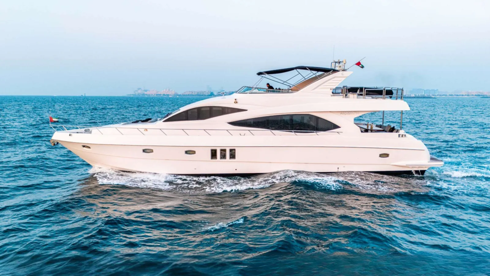 Majesty 77 yacht in full side profile on open water.