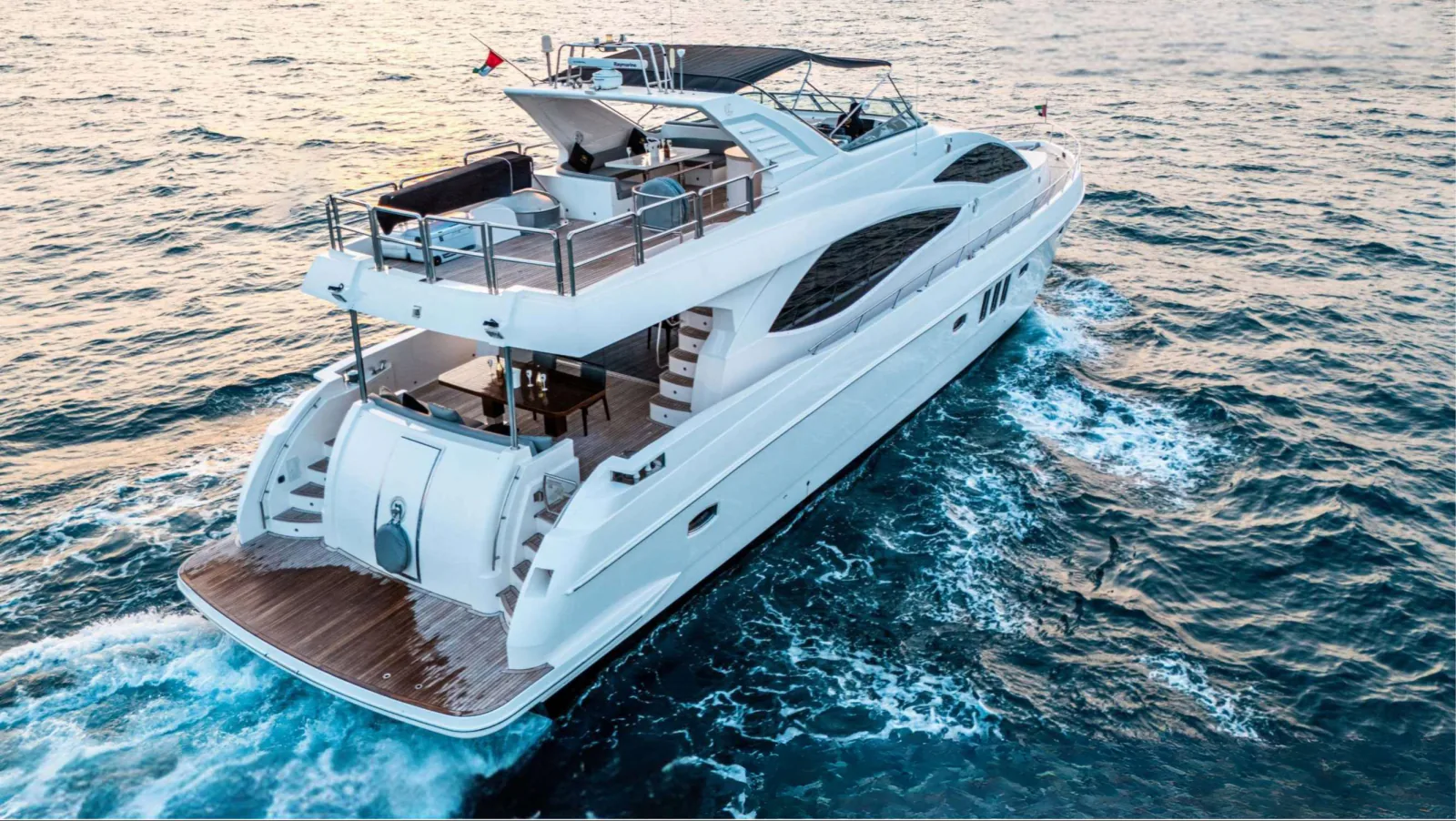 Majesty 77 yacht from above the stern quarter in warm evening light.