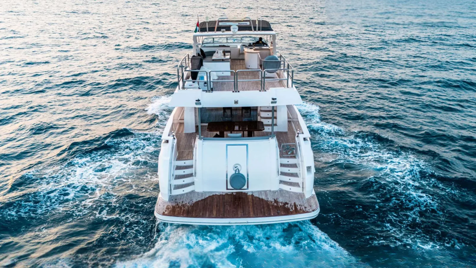 Majesty 77 yacht from astern showing the swim platform and boarding stairs.