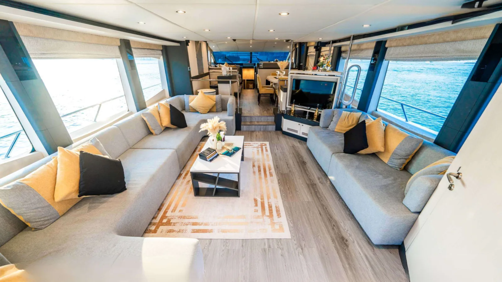 Majesty 77 yacht main saloon with facing sofas and large side windows.