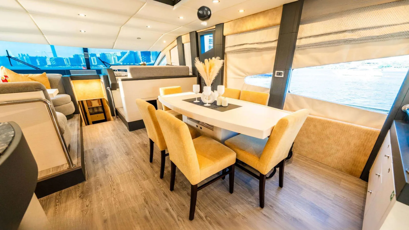 Majesty 77 yacht dining table and chairs beside the side windows.