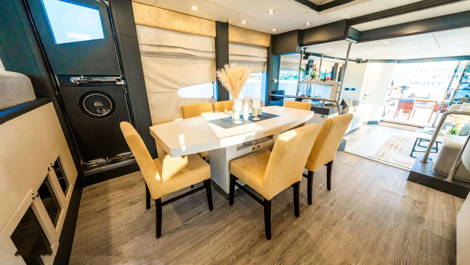 Majesty 77 yacht dining area beside the open aft doors.