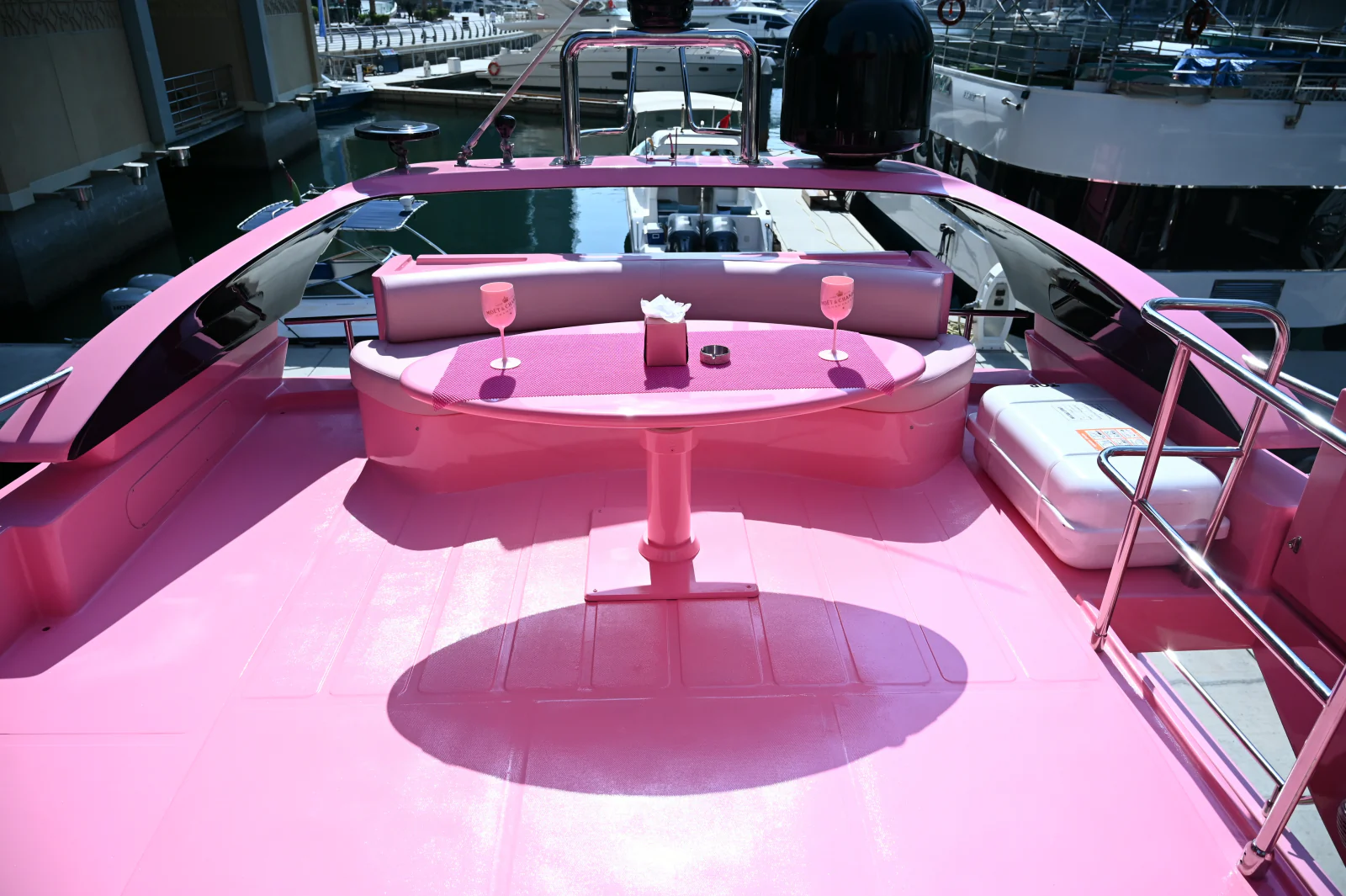 Pink yacht rental Dubai flybridge dining table with pink seating