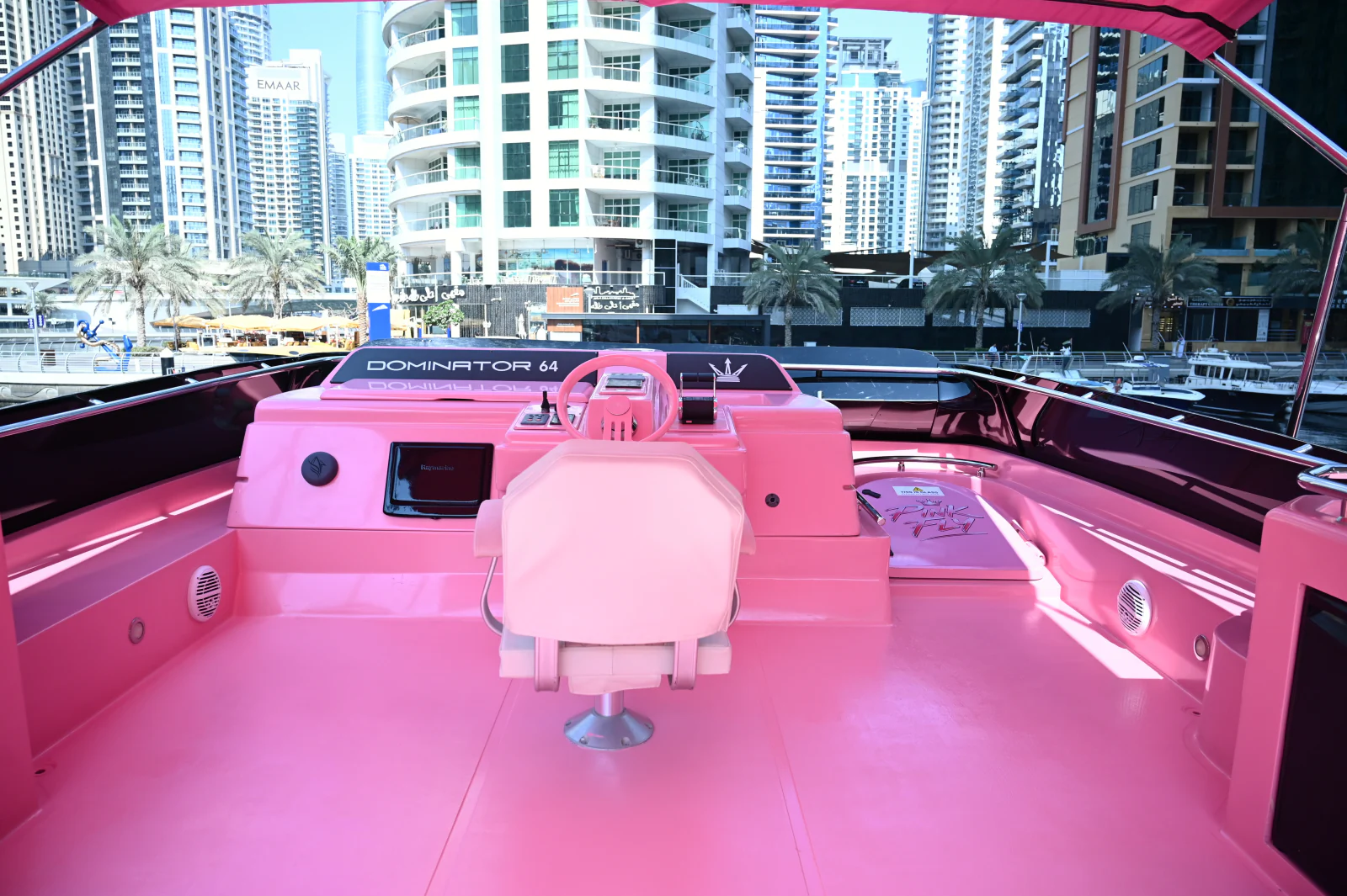 Pink yacht rental Dubai Dominator 64 flybridge helm and seating
