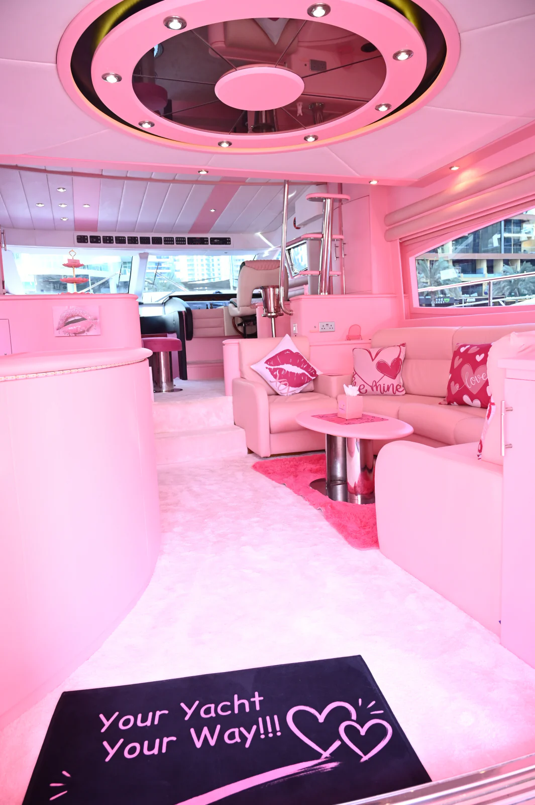 Pink yacht rental Dubai main saloon entrance with pink lounge seating