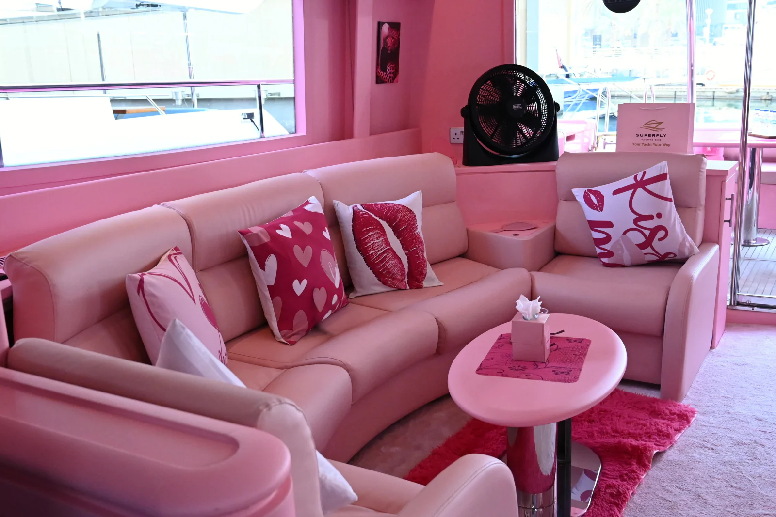 Pink yacht rental Dubai saloon seating with pink party cushions
