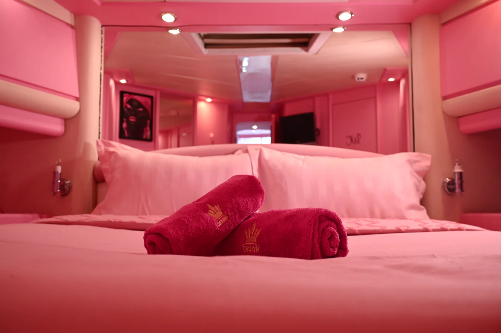Pink yacht rental Dubai master cabin with pink towels and lighting