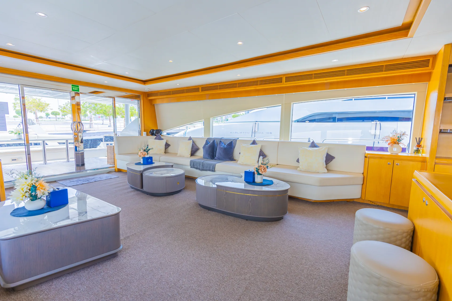 Rosso 110 main saloon with L-sofa and oval marble tables