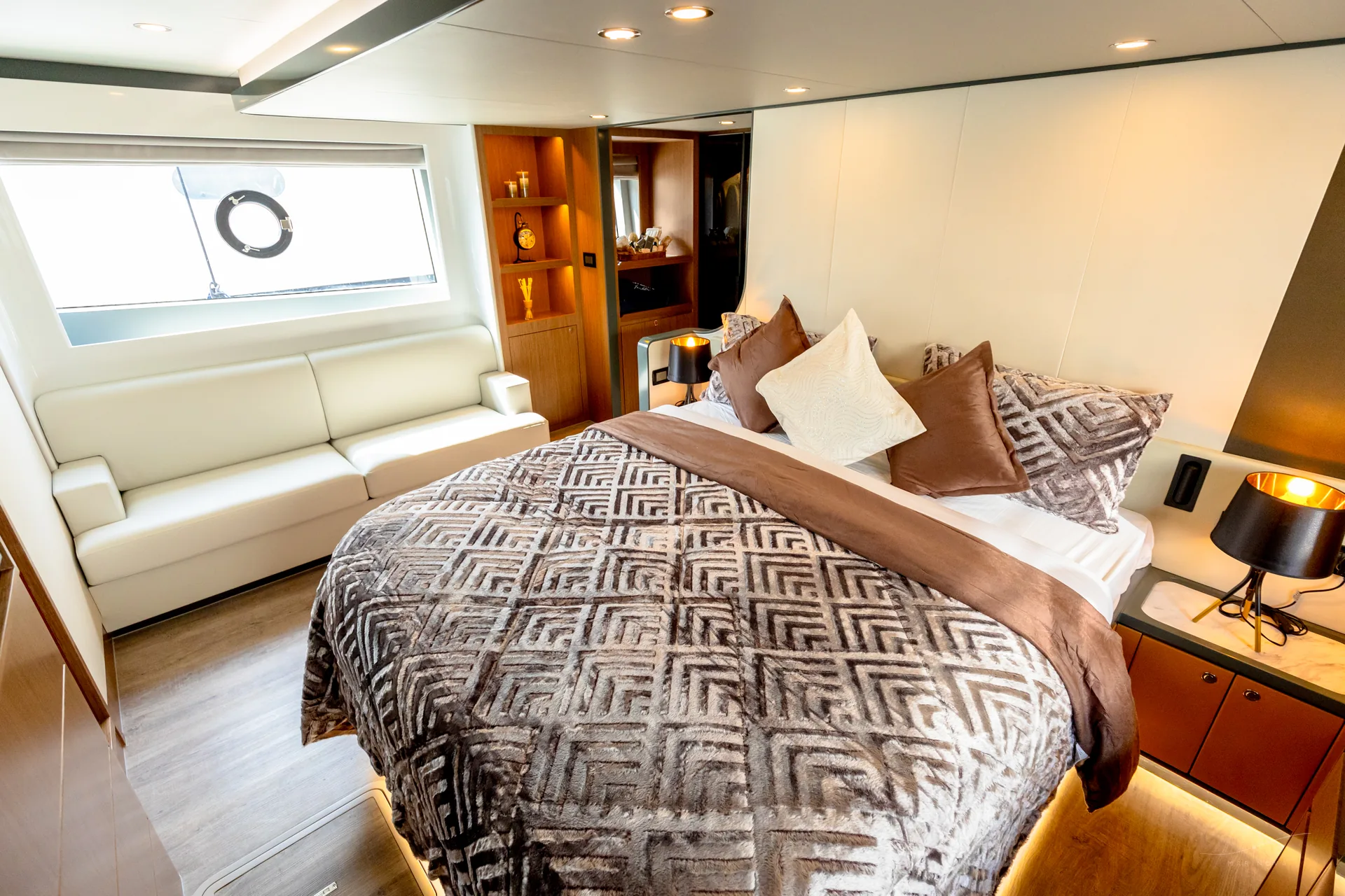 Vela 63 master cabin with side sofa and window